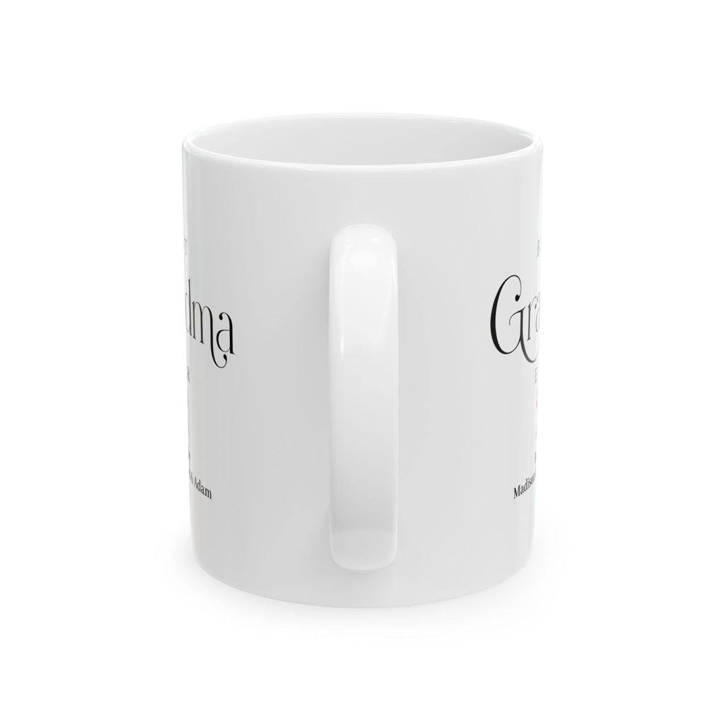 Personalized grandma birthday gift mug in home setting - elegant white ceramic with grandkids names