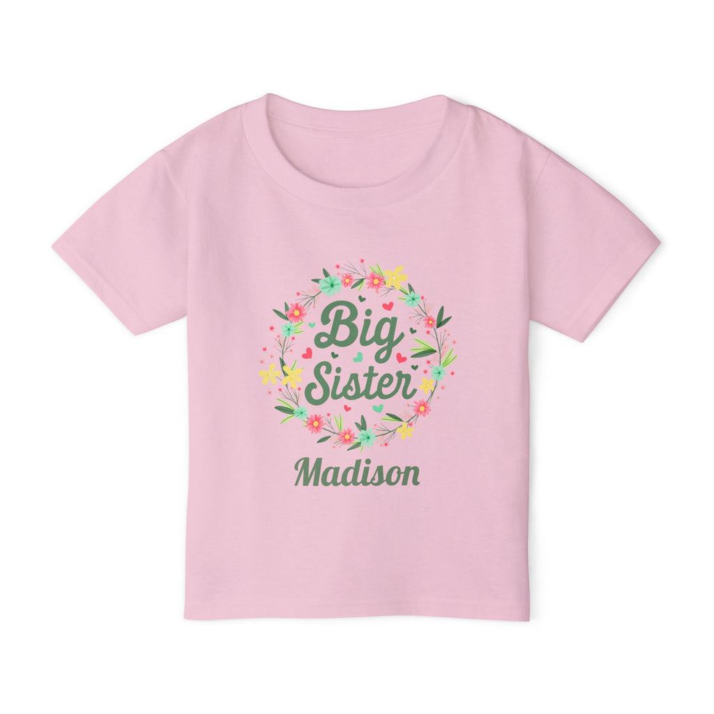 Close-up of Big Sister shirt design - floral wreath with hearts and personalized name in green script font