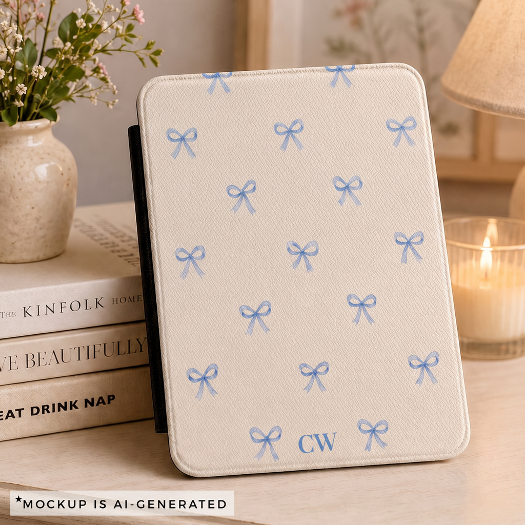 Blue bow Kindle Paperwhite cover flat lay - scattered watercolor ribbon bows on cream with personalized initials