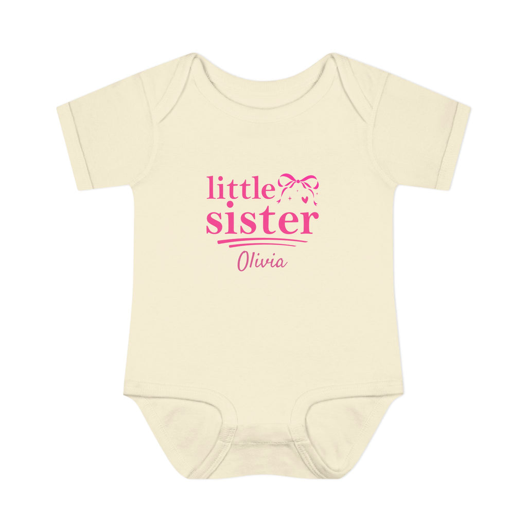 Close-up of Little Sister coquette onesie design - hot pink bow sparkles heart and personalized name in script font