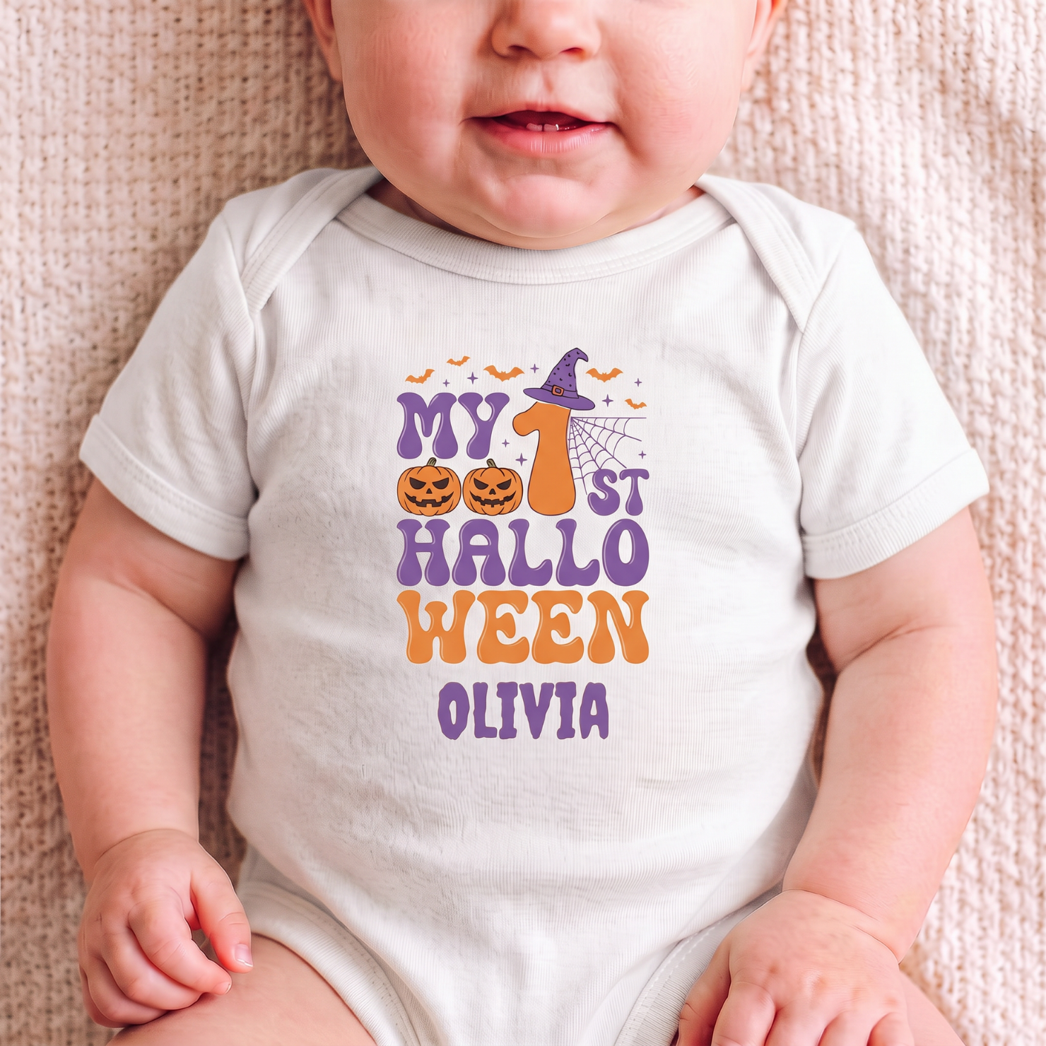 Close-up of My 1st Halloween onesie design - jack-o-lanterns witch hat spiderweb bats and personalized name in purple and orange