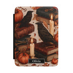 Personalized autumn raven Kindle case - gothic fall design with black ravens antique books candles pumpkins autumn leaves and custom name in black nameplate